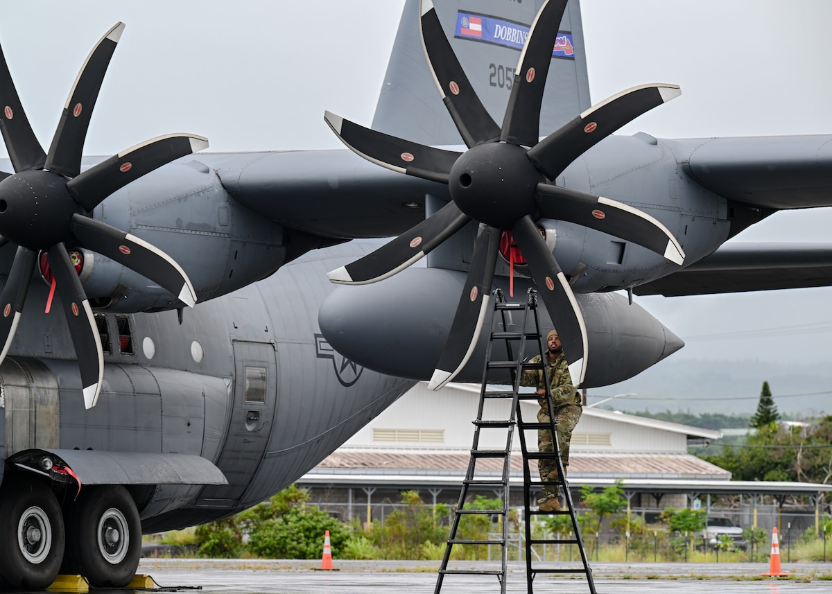 U.S. Air Force maintainer performs routine maintenance checks on a C-130H Hercules aircraft.