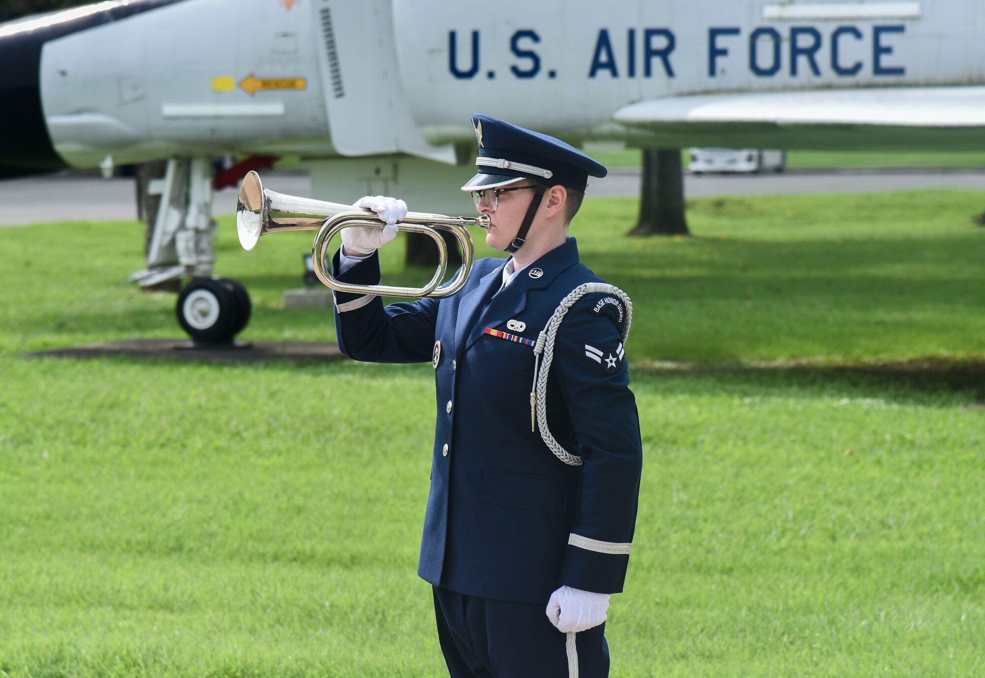 An honor guardsman plays the bugle.