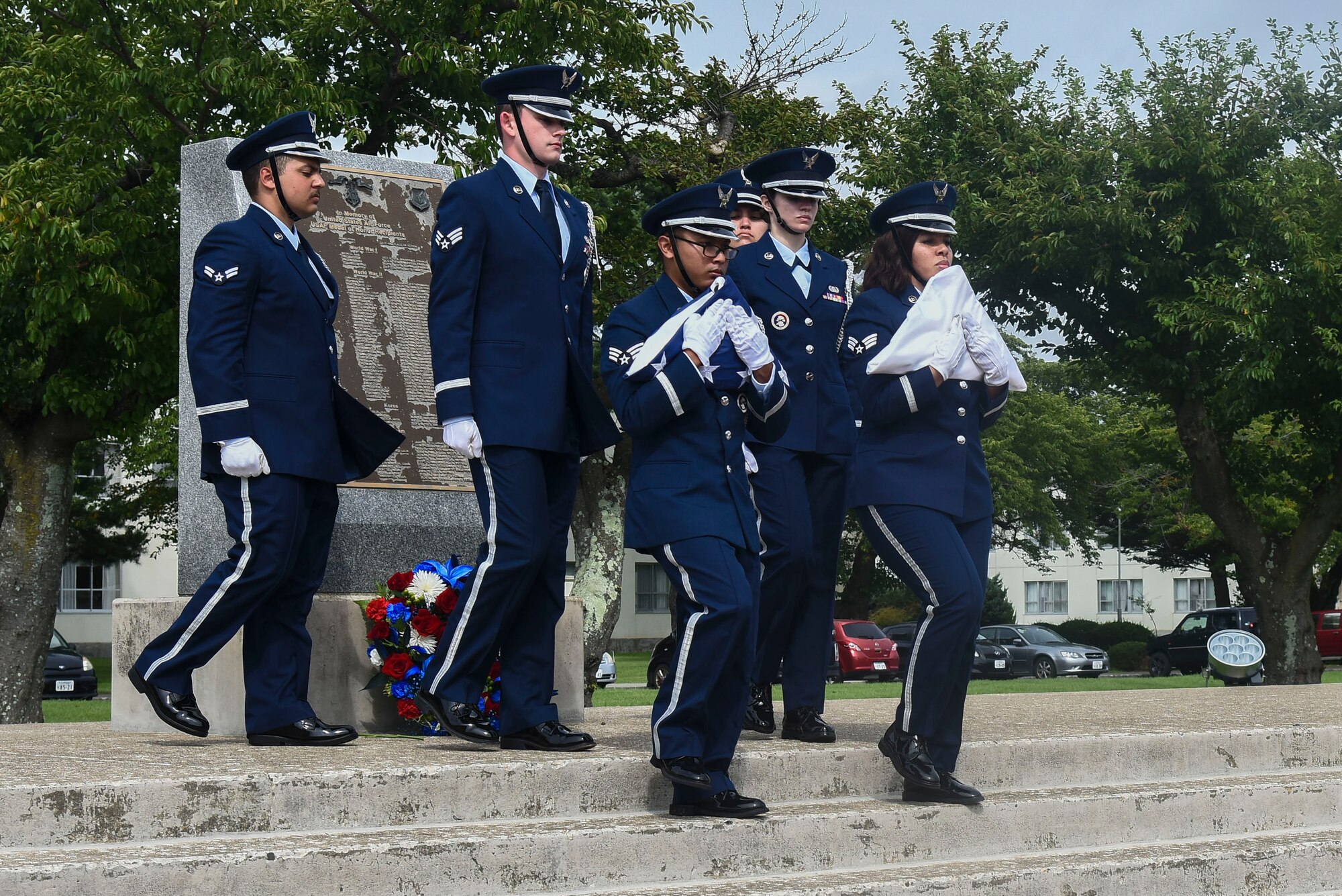 Honor guardsmen carry the U.S. and Japanese flag away.