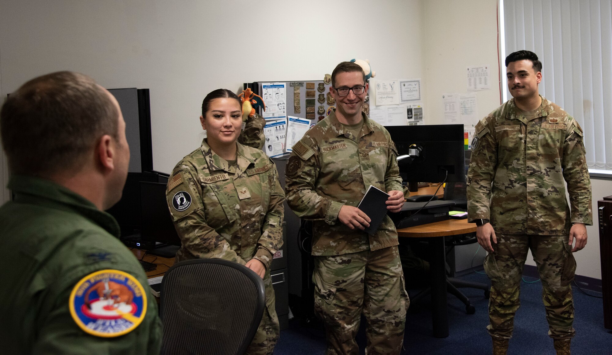 Military members talk to each other in an office