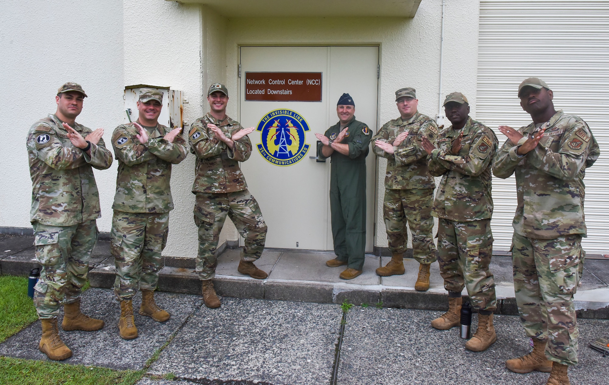 Military members hold up a pose