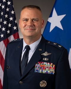 man in uniform smiles at camera