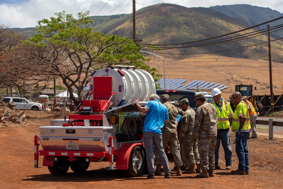 National Guard service members conduct set up operations of a rapid response emergency siren.