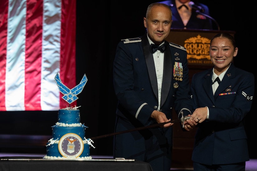 U.S. Air Force Col. Robert Grimmett, 87th Mission Support Group commander, and the youngest Airman in attendance cut the Air Force birthday cake during the Air Force ball hosted by Joint Base McGuire-Dix-Lakehurst at Atlantic City, N.J., on Sept. 16, 2023. This event is in celebration of the 76th birthday of the U.S. Air Force. (Photo by Airman 1st Class Aidan Thompson)