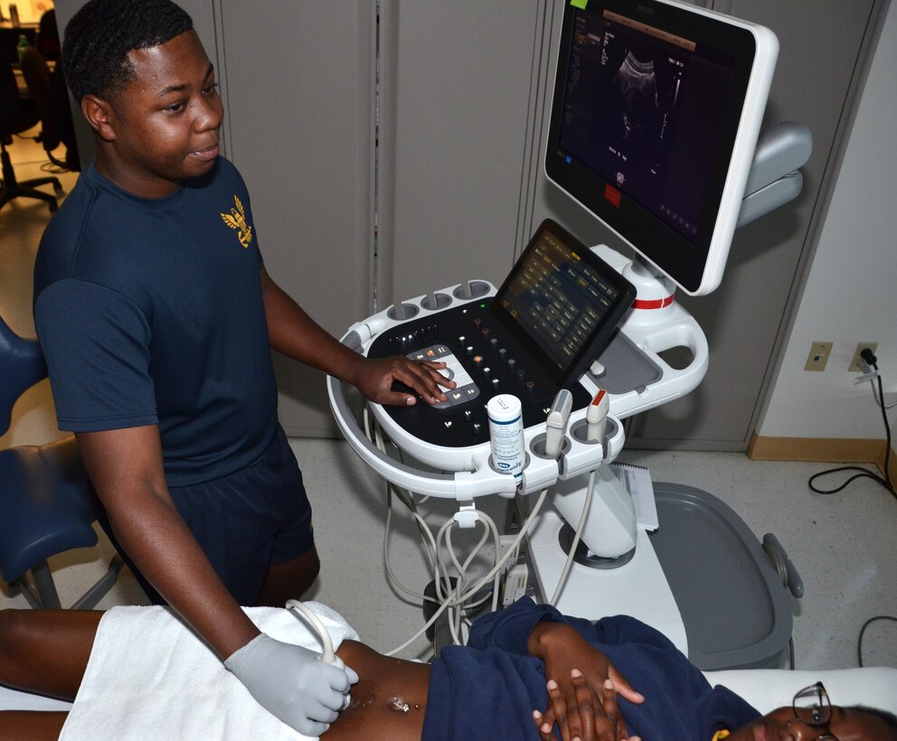 Hospital Corpsman Second Class Douglass Jones conducts a training scan in the Diagnostic Medical Sonographer program ultrasound laboratory at the Medical Education and Training Campus. Jones was praised for his outstanding attention to detail after recognizing a possible tumor in another student during a practice scan, enabling the student to receive expedited follow-up care.