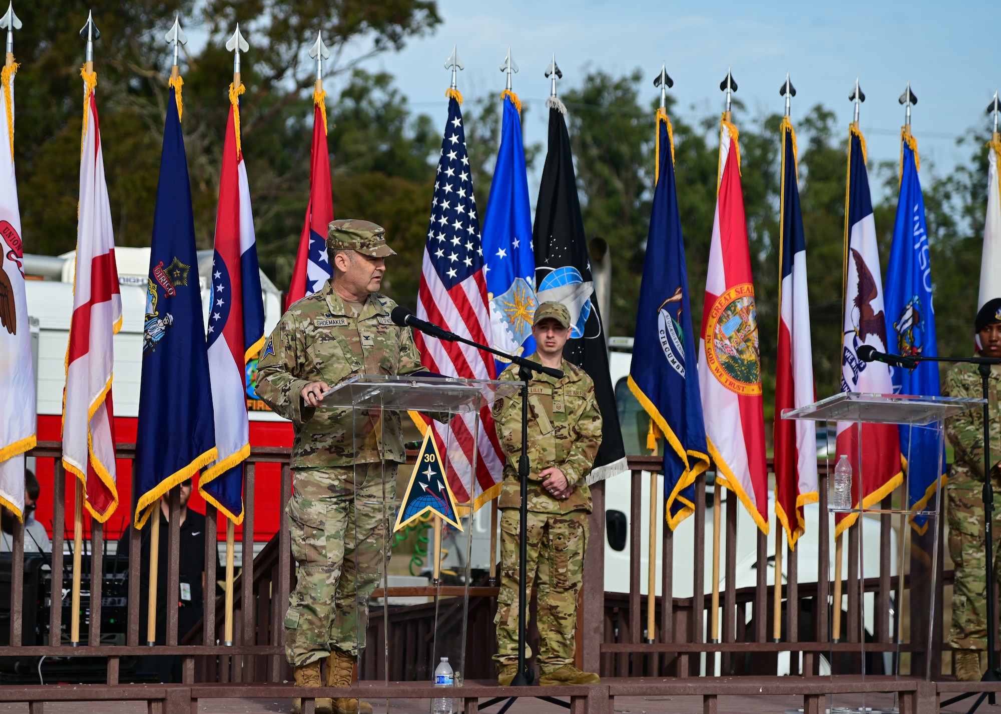 A man in uniform gives a speech during a ceremony.