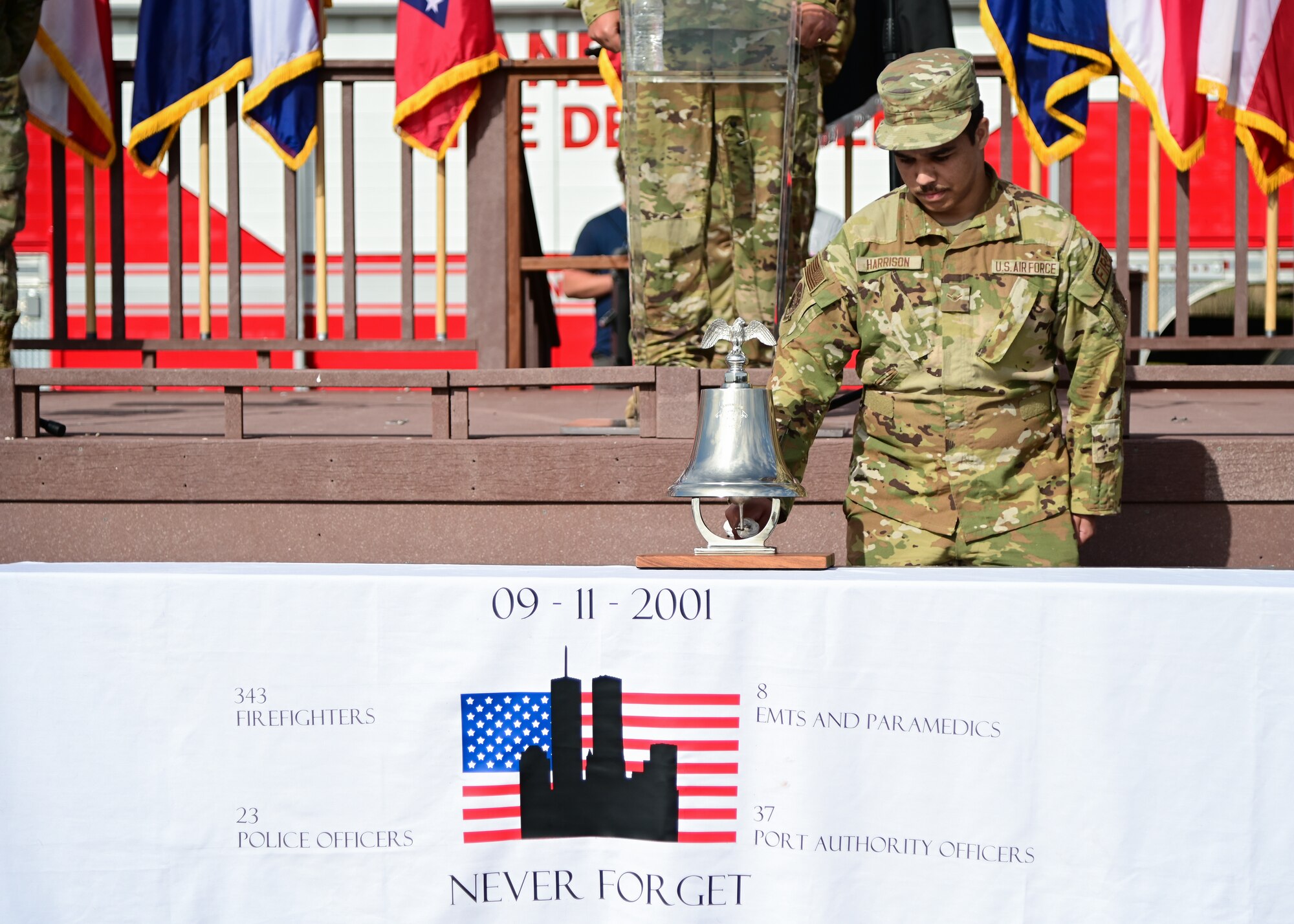 A man in uniform rings a bell during a ceremony.