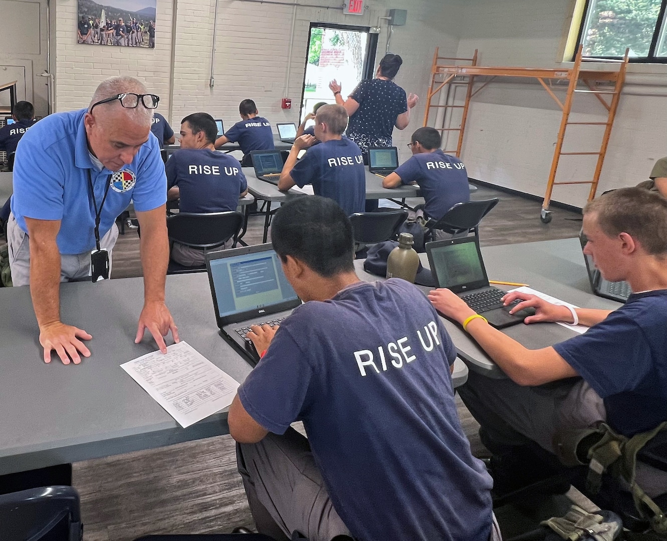 Air Force Maj. Chavery McClanahan, Butte MEPS commander and Army 1st Sgt. Tony Cohen, Butte MEPS SEA, pose with a Montana Youth Challenge Academy (MYCA) class. MYCA helps teens at risk of not graduating with a residential program that uses the ASVAB Career Exploration Program to learn about their individual skills and interests