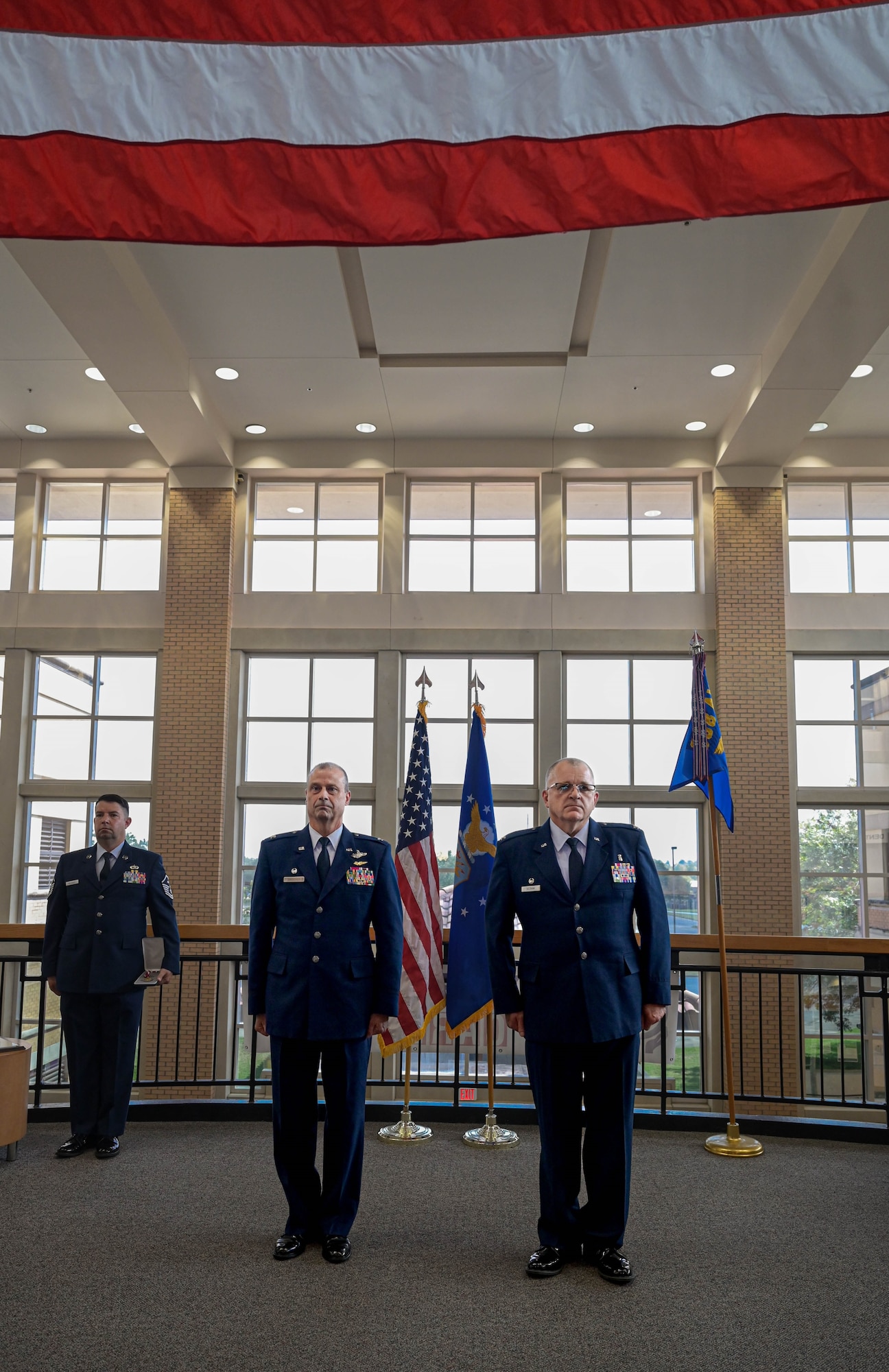 two men stand at attention during a ceremony