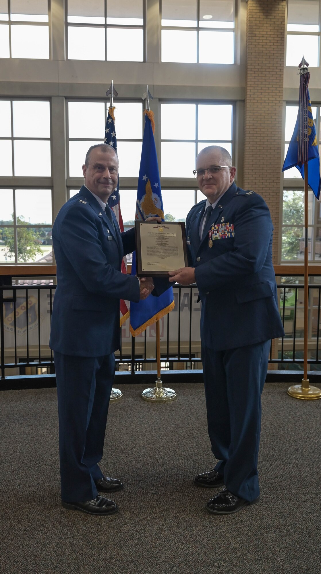 two men pose for a photo