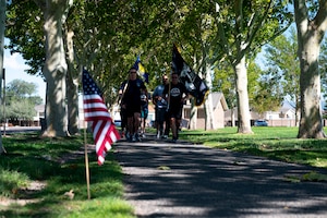 People run holding flag.