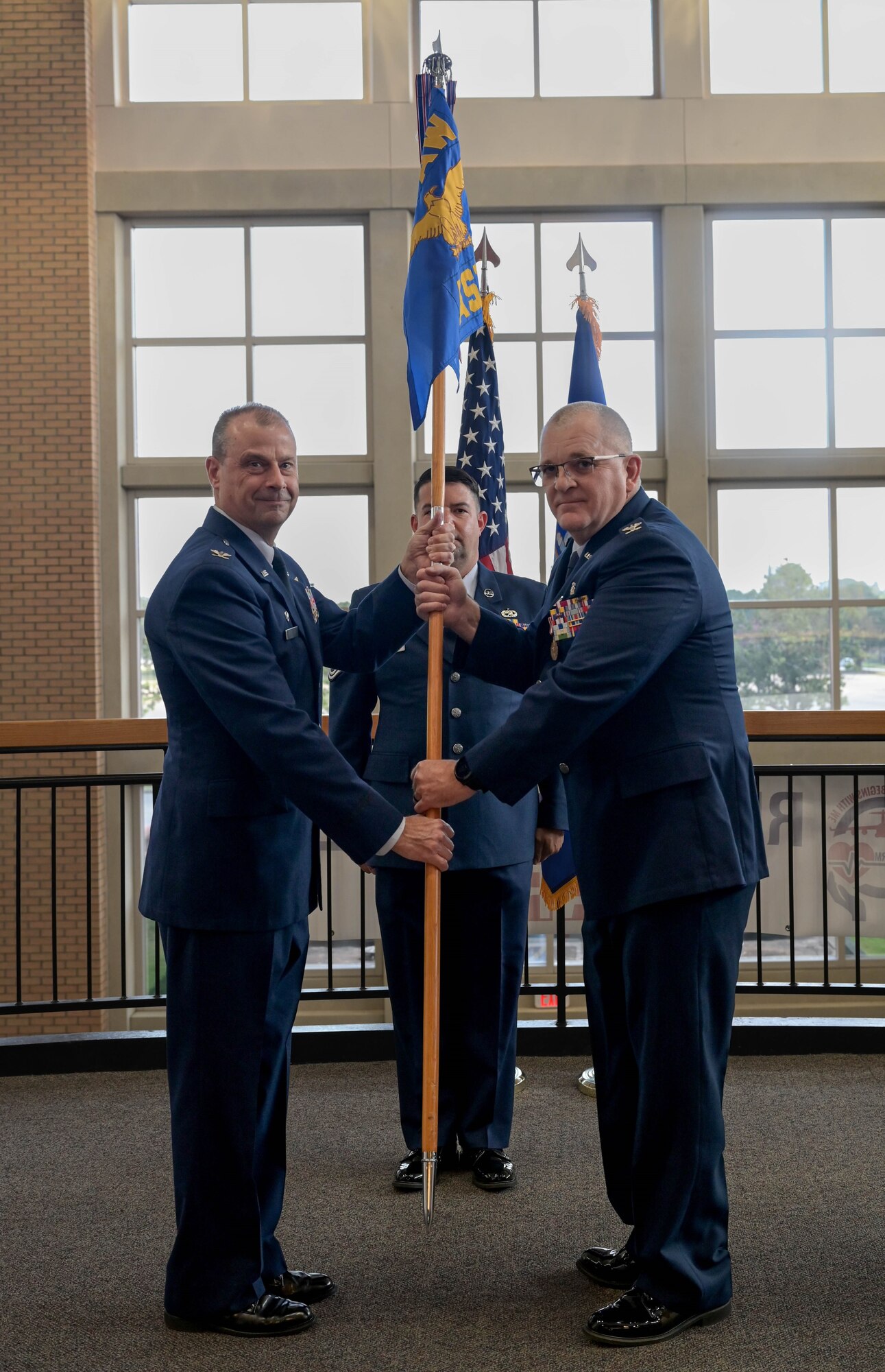 a man passes a flag to another man