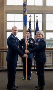 a man passes a flag to a woman
