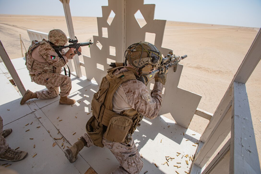 U.S. Marine Corps Capt. Sean Rusaw, Air Officer, Battalion Landing Team 1/6, 26th Marine Expeditionary Unit (Special Operations Capable) (26MEU(SOC), fires his M27 infantry automatic rifle alongside a Kuwaiti Marine during live-fire training at Udairi Range Complex, Kuwait, Sept. 4, 2023. Elements of the 26MEU(SOC) conducted bilateral training with Kuwait armed forces to increase interoperability, maintain operational readiness, and strengthen relationships with partner forces. Components of the Bataan Amphibious Ready Group and 26th Marine Expeditionary Unit are deployed to the U.S. 5th Fleet area of operations to help ensure maritime security and stability in the Middle East region. (U.S. Marine Corps photo by Gunnery Sgt. Jeffrey Cordero)
