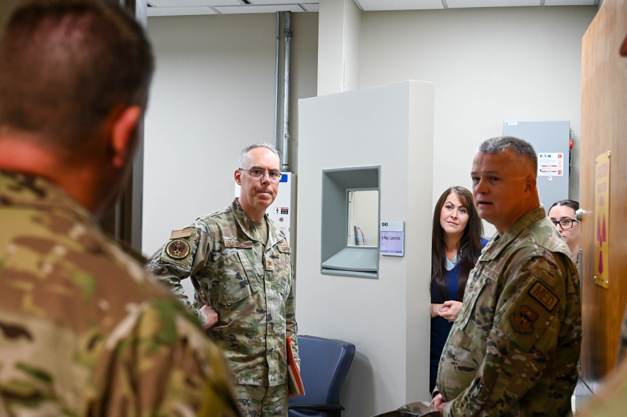 U.S. Air Force Col. Christopher Grussendorf, left, Air Education and Training Command (AETC) surgeon general, and Chief Master Sgt. Donald Cook, right, AETC chief of enlisted medical force, walk through the x-ray room with members of the radiology team from the 97th Healthcare Operations Squadron, during a tour at Altus Air Force Base, Oklahoma, Sept. 13, 2023. Members of the radiology clinic upgraded their medical equipment to help clinicians deliver more precise and efficient care. (U.S. Air Force photo by Airman 1st Class Heidi Bucins)