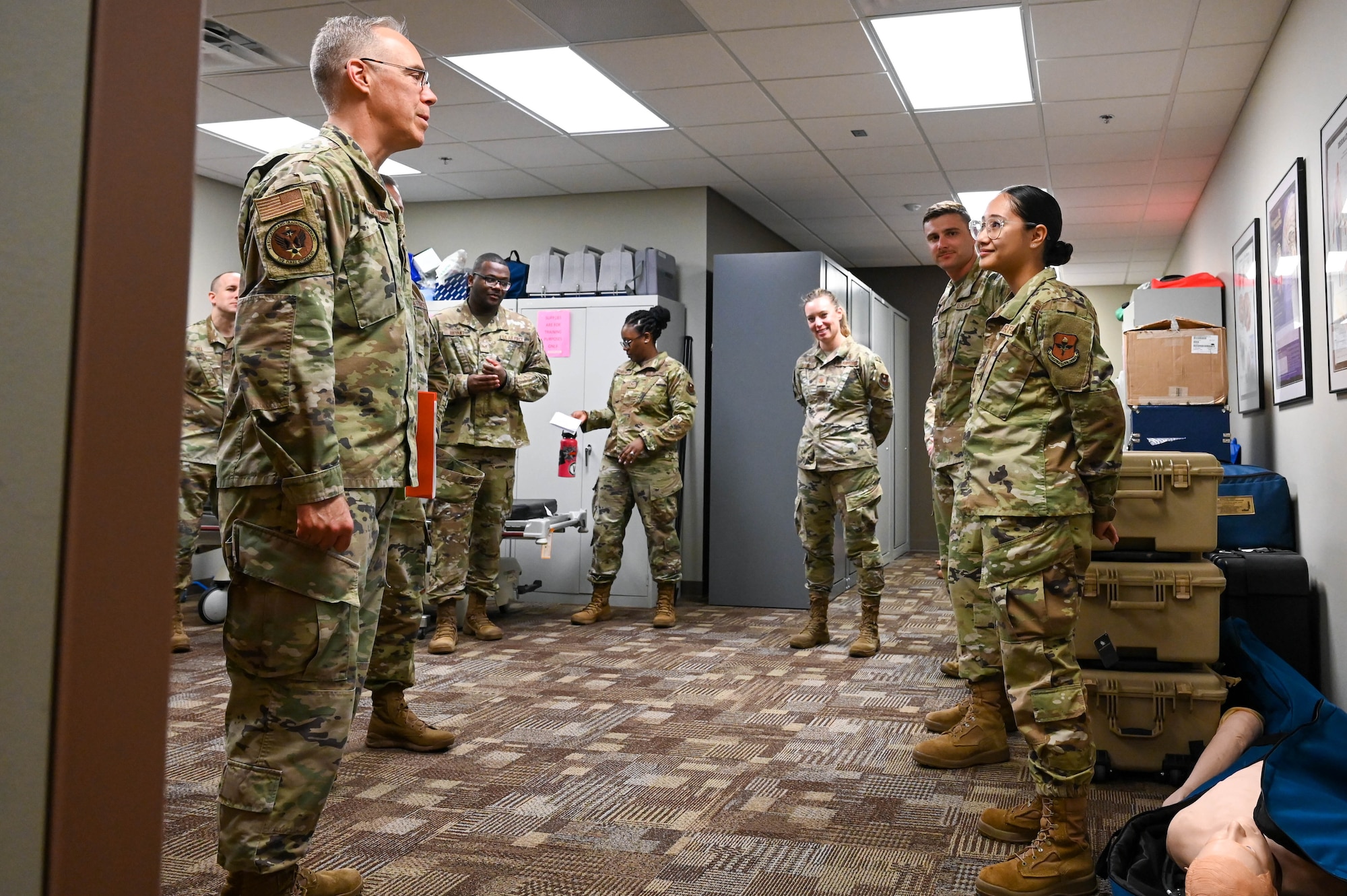 U.S. Air Force Col. Christopher Grussendorf, Air Education and Training Command surgeon general, left, meets Airmen from the 97th Operational Medical Readiness Squadron Mental Health Flight, during a tour of the medical group facility at Altus Air Force Base, Oklahoma, Sept. 13, 2023. Members of the mental health clinic implemented the Behavioral Health Resource and Virtual Experience (BRAVE) program that has created an additional 20 appointment slots of coverage per week for Airmen. (U.S. Air Force photo by Airman 1st Class Heidi Bucins)