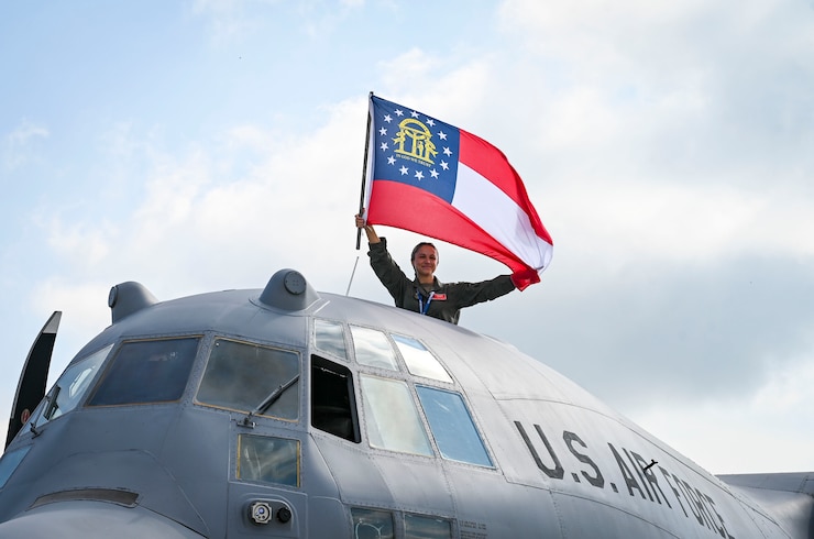 United States Airman holding Georgia state flag