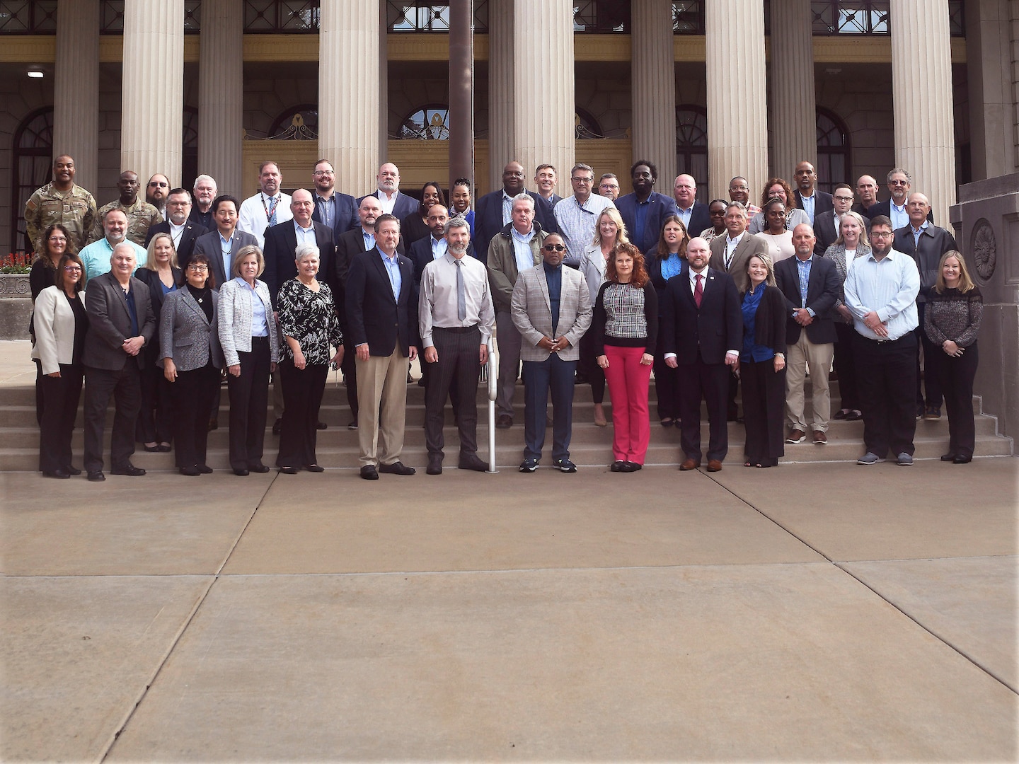 Group shot of attendees on stairs with columns in backgroud