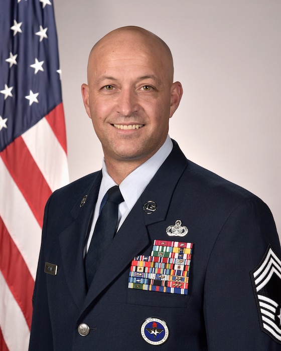 U.S. Air Force Chief Master Sgt. Christopher Clark poses for an official photo. Clark serves as one of two Senior Enlisted Leaders for Space Base Delta 1.
