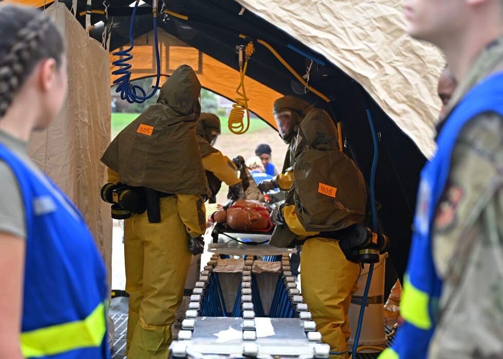 Airmen assigned to the 17th Medical Group perform decontamination procedures during a Ready EAGLE II exercise at Goodfellow Air Force Base, Texas, Sept. 14, 2023. Decontamination removed simulated harmful substances from the medical mannequin. (U.S. Air Force photo by Senior Airman Sarah Williams)