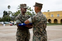 U.S. Marine Corps Cpl. Malachi Groff, a military police officer with Headquarters and Service Battalion, Marine Corps Recruit Depot San Diego, receives the American flag in honor of his Military Working Dog Nero, during a memorial ceremony at MCRD San Diego, Sept. 18, 2023. MWD Nero showed great dedication and courage while working on MCRD San Diego from June 11, 2021 through Sept. 9, 2023. (U.S. Marine Corps photo by Sgt. Yvonna Guyette)