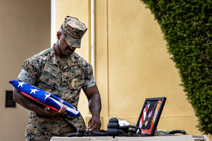 U.S. Marine Corps Cpl. Malachi Groff, a military police officer with Headquarters and Service Battalion, Marine Corps Recruit Depot San Diego, honors his Military Working Dog Nero, during a memorial ceremony at MCRD San Diego, Sept. 18, 2023. MWD Nero showed great dedication and courage while working on MCRD San Diego from June 11, 2021 through Sept. 9, 2023. (U.S. Marine Corps photo by Sgt. Yvonna Guyette)