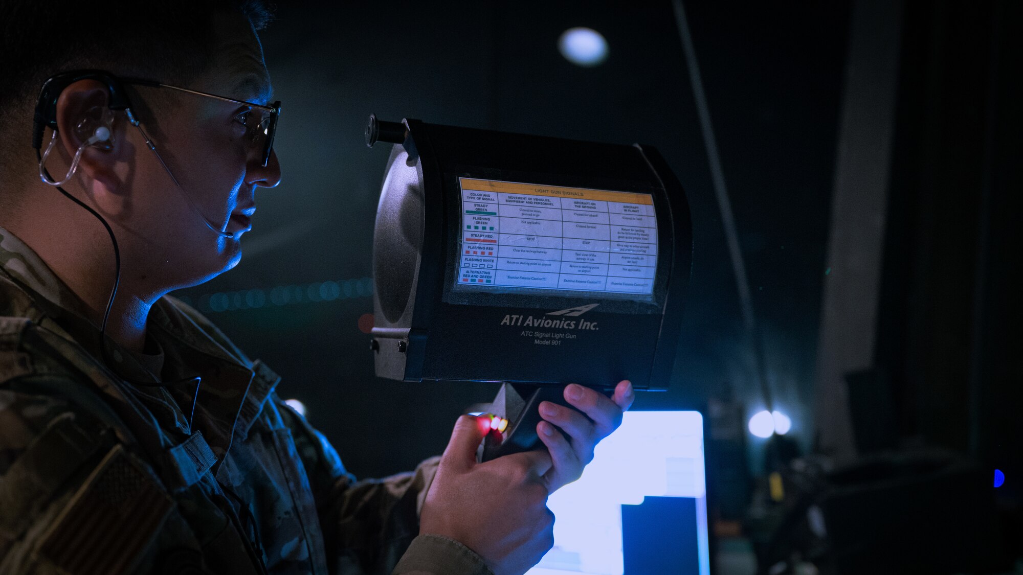 Senior Airman Francisco Reza conducts a light signal test during Beverly Pack 23-3.