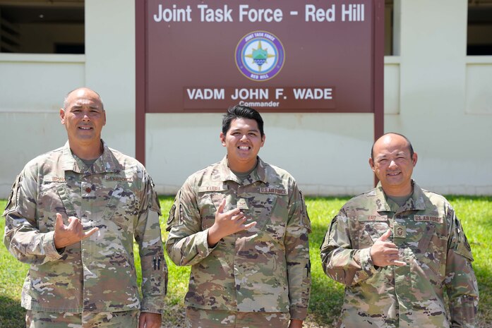 Joint Task Force Red-Hill (JTF-RH) Planning Directorate Action Officer, U.S. Air National Guard Major Jeremy Wong, JTF-RH Access Control Point, U.S. Air National Guard Airman First Class Kaeden Kairua, and JTF-RH Air Force Senior Enlisted Leader, U.S. Air National Guard Senior Master Sgt. Steven J. Kau stand outside of JTF-RH Headquarters on Ford Island, Hawaii, Aug. 15, 2023. JTF-RH is in phase four of its five-phase defueling plan. The primary focus of phase four is achieving final coordination between the Hawaii Department of Health, the Environmental Protection Agency, and the Department of Defense before beginning gravity defueling. (DoD photo by U.S. Air National Guard Tech. Sgt. Nicholas Brown)