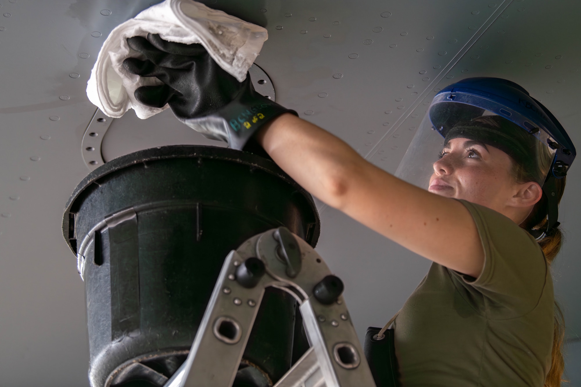 SrA Jibben wiping and draining excess fuel.