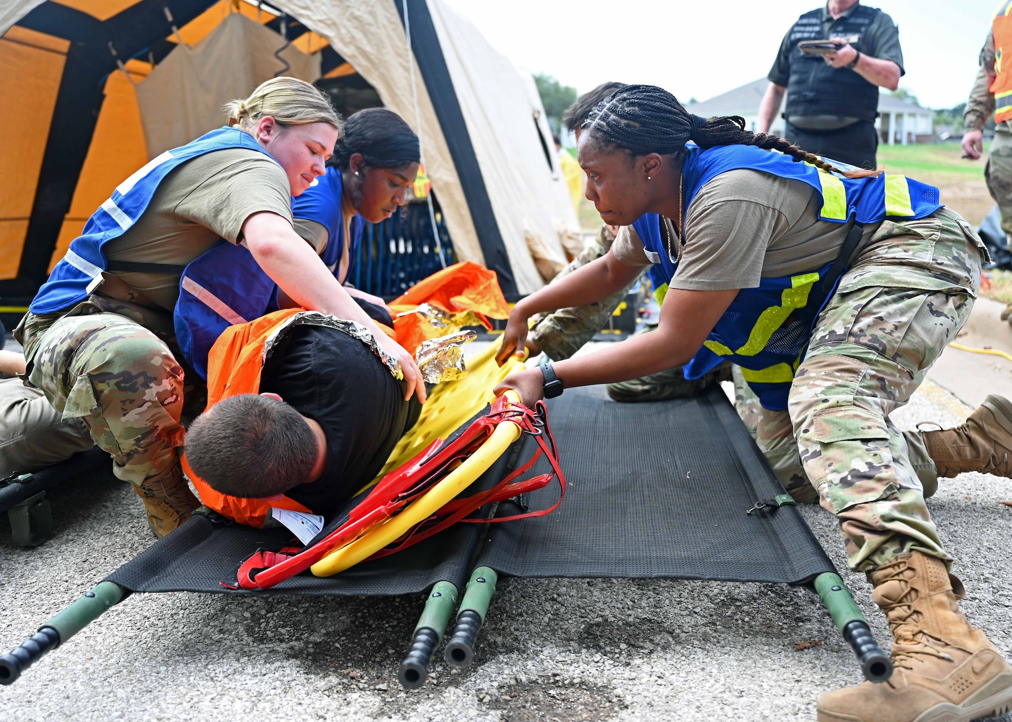 Airmen assigned to the 17th Medical Group transfer a simulated patient from a wet litter to a dry litter during a Ready EAGLE II exercise at Goodfellow Air Force Base, Texas, Sept. 14, 2023. Wet litters were taken to primary triage to transport simulated patients to decontamination. (U.S. Air Force photo by Senior Airman Sarah Williams)