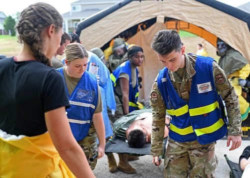 Airmen assigned to the 17th Medical Group carry a simulated patient during a Ready EAGLE II exercise at Goodfellow Air Force Base, Texas, Sept. 14, 2023. Patients were removed from the decontamination and placed on the ground for simulated secondary medical care. (U.S. Air Force photo by Senior Airman Sarah Williams)