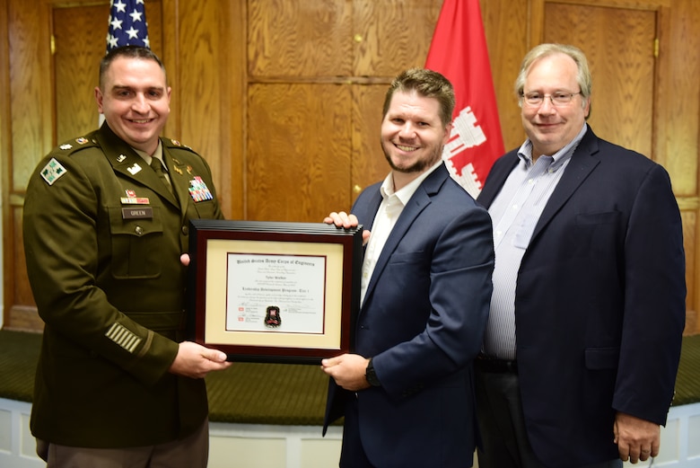 Tyler Walker, U.S. Army Corps of Engineers Nashville District, receives a certificate of completion for the 2023 Leadership Development Program Level I Course from Lt. Col. Robert W. Green, Nashville District commander, and Michael Evans, course instructor, during a graduation ceremony Sept. 13, 2023, at the Scarritt Bennett Center in Nashville, Tennessee. (USACE Photo by Lee Roberts)