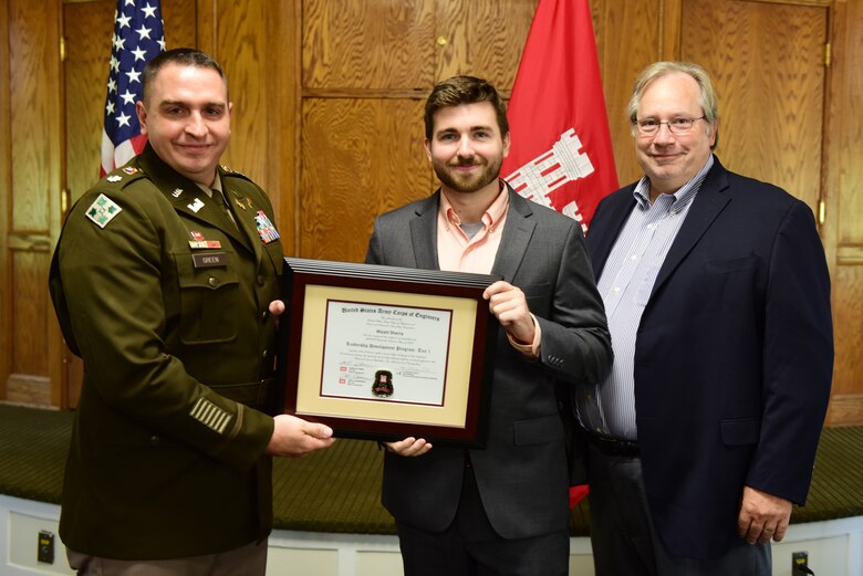 Wyatt Sherry, U.S. Army Corps of Engineers Nashville District, receives a certificate of completion for the 2023 Leadership Development Program Level I Course from Lt. Col. Robert W. Green, Nashville District commander, and Michael Evans, course instructor, during a graduation ceremony Sept. 13, 2023, at the Scarritt Bennett Center in Nashville, Tennessee. (USACE Photo by Lee Roberts)