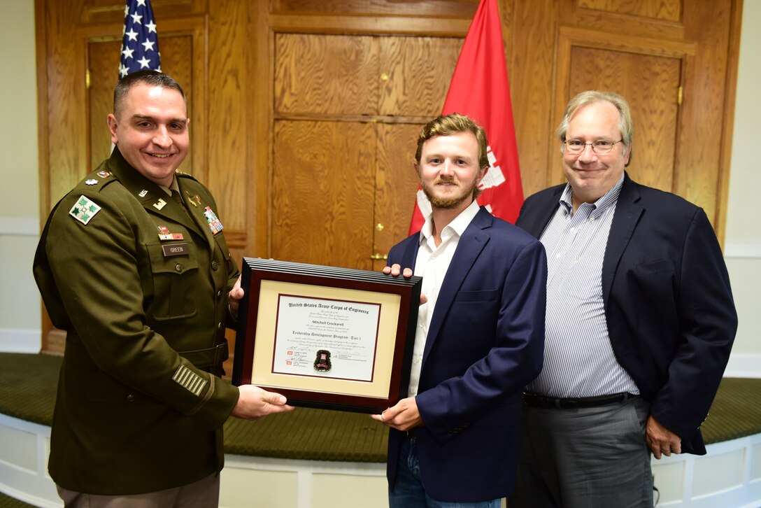 Mitchell Crockarell, U.S. Army Corps of Engineers Nashville District, receives a certificate of completion for the 2023 Leadership Development Program Level I Course from Lt. Col. Robert W. Green, Nashville District commander, and Michael Evans, course instructor, during a graduation ceremony Sept. 13, 2023, at the Scarritt Bennett Center in Nashville, Tennessee. (USACE Photo by Lee Roberts)