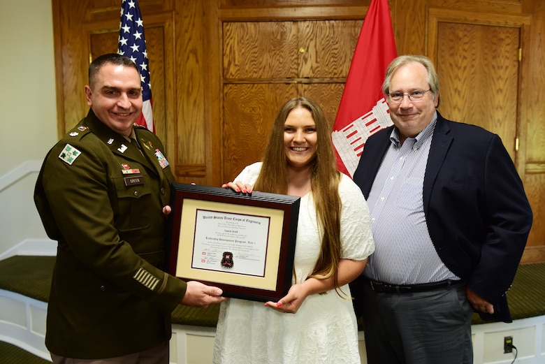 Cayce Grall, U.S. Army Corps of Engineers Nashville District, receives a certificate of completion for the 2023 Leadership Development Program Level I Course from Lt. Col. Robert W. Green, Nashville District commander, and Michael Evans, course instructor, during a graduation ceremony Sept. 13, 2023, at the Scarritt Bennett Center in Nashville, Tennessee. (USACE Photo by Lee Roberts)