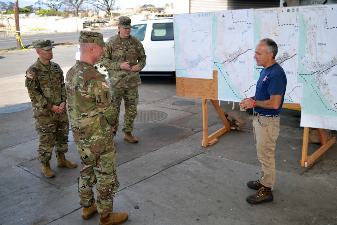 A government leader talks to service members.