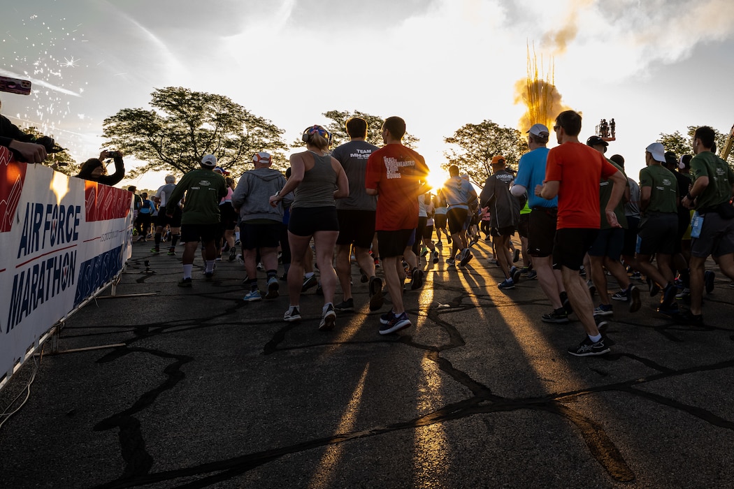 A group of runners leaving the starting line area