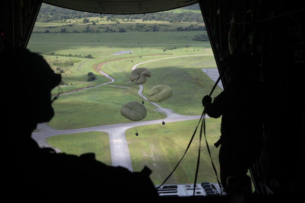 Three 824th Base Defense Squadron cargo packages parachute onto Avon Park Air Force Range, Florida, after being dropped from an HC-130J Combat King II on August 21, 2023. Air mobility assets are able to provide supply and sustainment of austere operating locations while minimizing threat to air assets. (U.S. Air Force photo by 1st Lt. Christian Little)