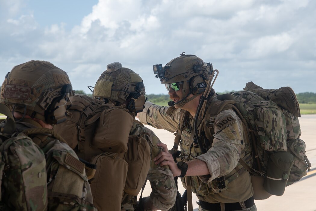 U.S. Air Force Lt. Col. Ryan Kiggins, 824th Base Defense Squadron commander, directs troops offloading from an HC-130J Combat King II at Avon Park, Florida, August 21, 2023. 824th BDS Airmen proved they were ready to provide security and support for upcoming Lead Wing operations through their mission readiness exercise. (U.S. Air Force photo by 1st Lt. Christian Little)