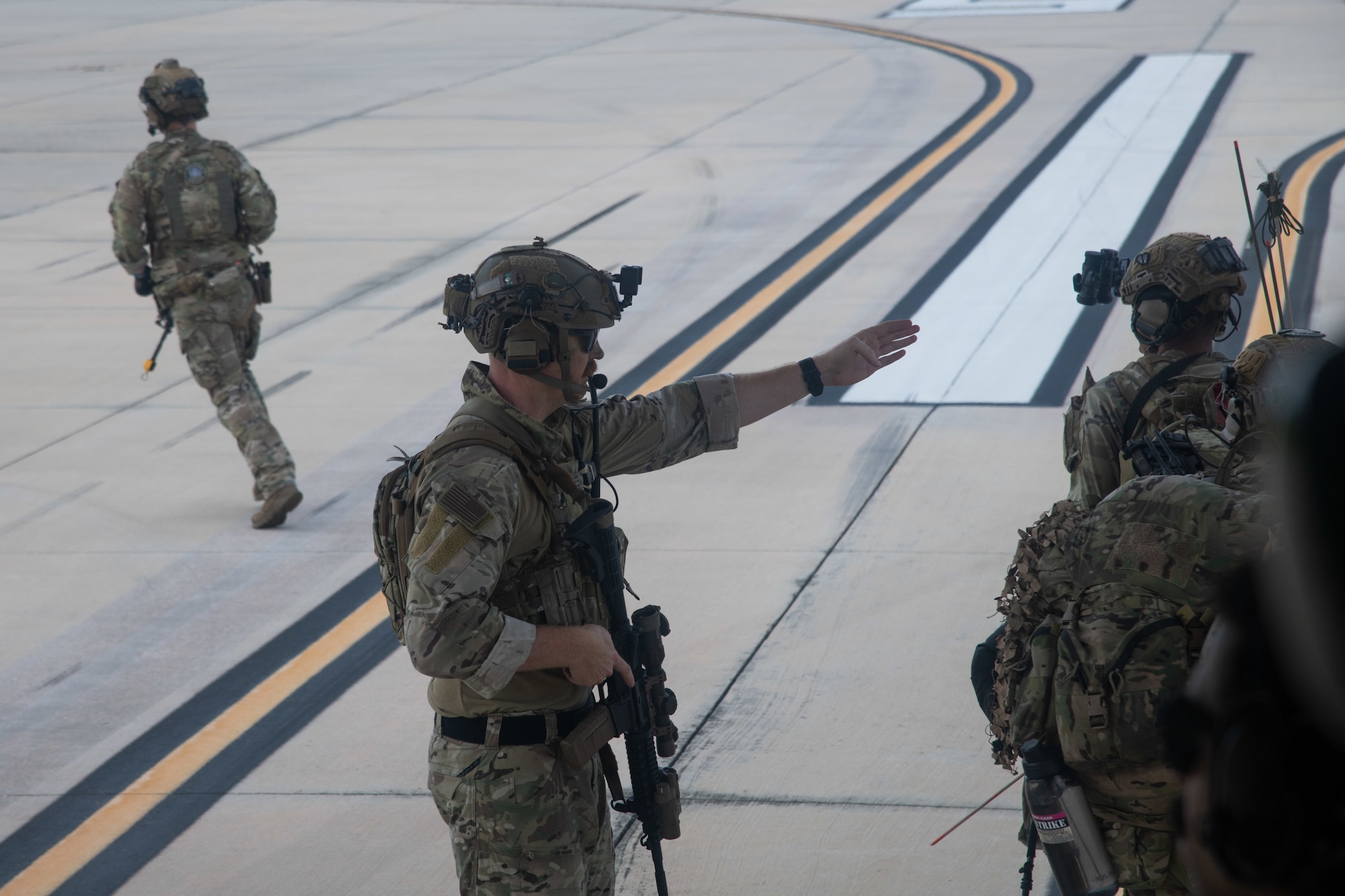 U.S. Air Force Lt. Col. Ryan Kiggins, 824th Base Defense Squadron commander, directs troops offloading from an HC-130J Combat King II at Avon Park, Florida, August 21, 2023. 824th BDS Airmen proved they were ready to provide security and support for upcoming Lead Wing operations through their mission readiness exercise. (U.S. Air Force photo by 1st Lt. Christian Little)