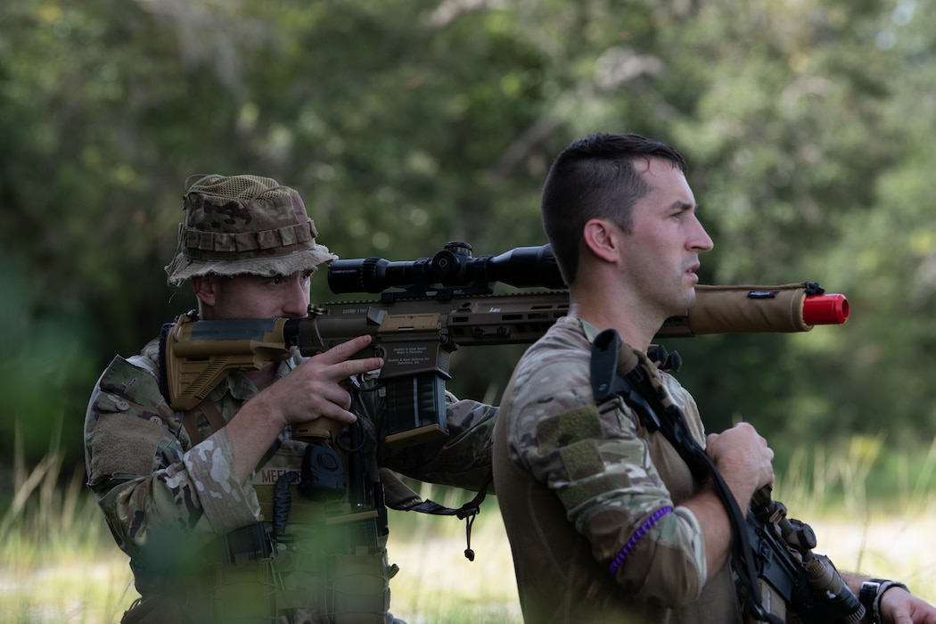 U.S. Air Force Staff Sgt. Dallas Meeler, 824th Base Defense Squadron reconnaissance and surveillance team lead, stabilizes a rifle on Staff Sgt. Rowen Love’s, 824th BDS member, shoulder at Avon Park Air Force Range, Florida, August 22, 2023. 824th BDS Airmen proved they were ready to provide security and support for upcoming Lead Wing operations through their mission readiness exercise. (U.S. Air Force photo by 1st Lt. Christian Little)