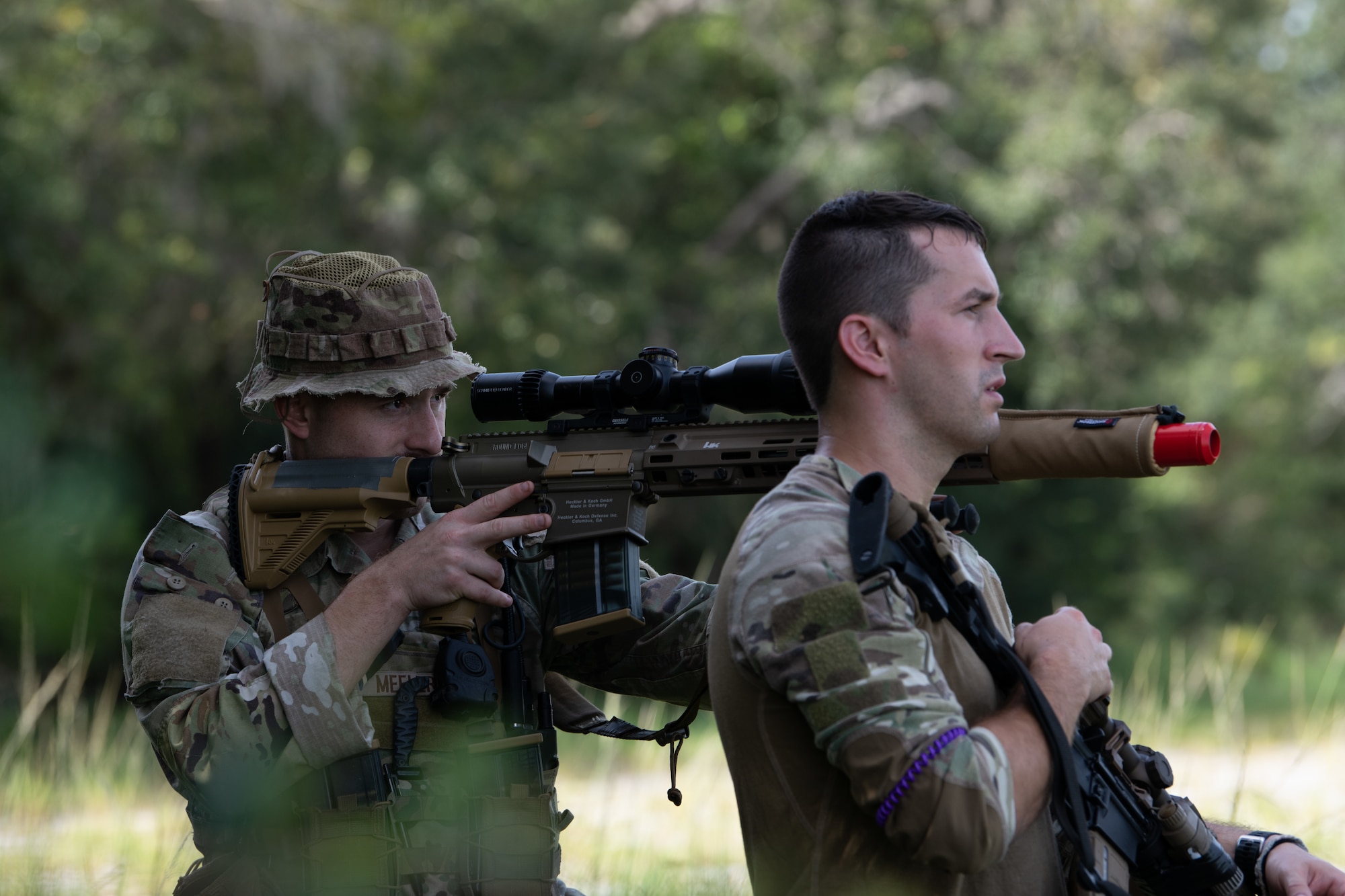 U.S. Air Force Staff Sgt. Dallas Meeler, 824th Base Defense Squadron reconnaissance and surveillance team lead, stabilizes a rifle on Staff Sgt. Rowen Love’s, 824th BDS member, shoulder at Avon Park Air Force Range, Florida, August 22, 2023. 824th BDS Airmen proved they were ready to provide security and support for upcoming Lead Wing operations through their mission readiness exercise. (U.S. Air Force photo by 1st Lt. Christian Little)