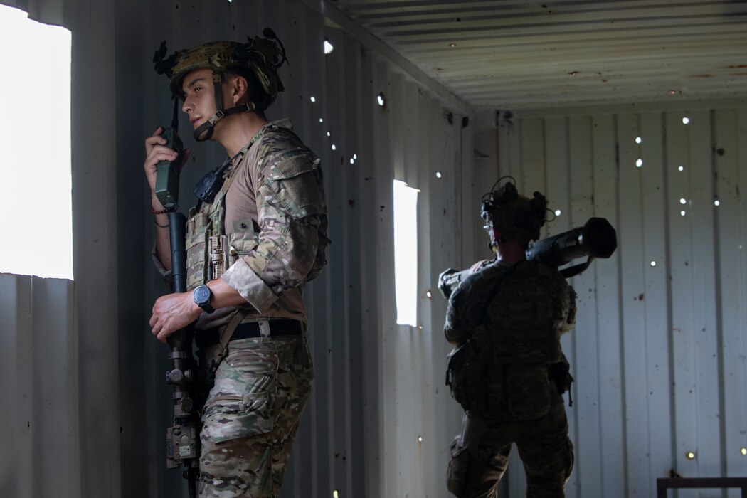 U.S. Air Force Airmen from the 824th Base Defense Squadron talk on a radio and defend a contingency location at Avon Park Air Force Range, Florida, August 22, 2023. 824th BDS Airmen proved they were ready to provide security and support for upcoming Lead Wing operations through their mission readiness exercise. (U.S. Air Force photo by 1st Lt. Christian Little)