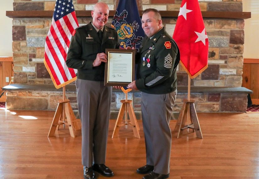 Command Sgt. Maj. Jon Worley, right, receives an award from Maj. Gen. Mark Schindler, the adjutant general, during his retirement ceremony Sept. 15 at Fort Indiantown Gap after 38 years of service in the National Guard and U.S. Army three years as the Pennsylvania National Guard’s senior enlisted leader. (U.S. Army National Guard photo by Sgt. 1st Class Zane Craig)