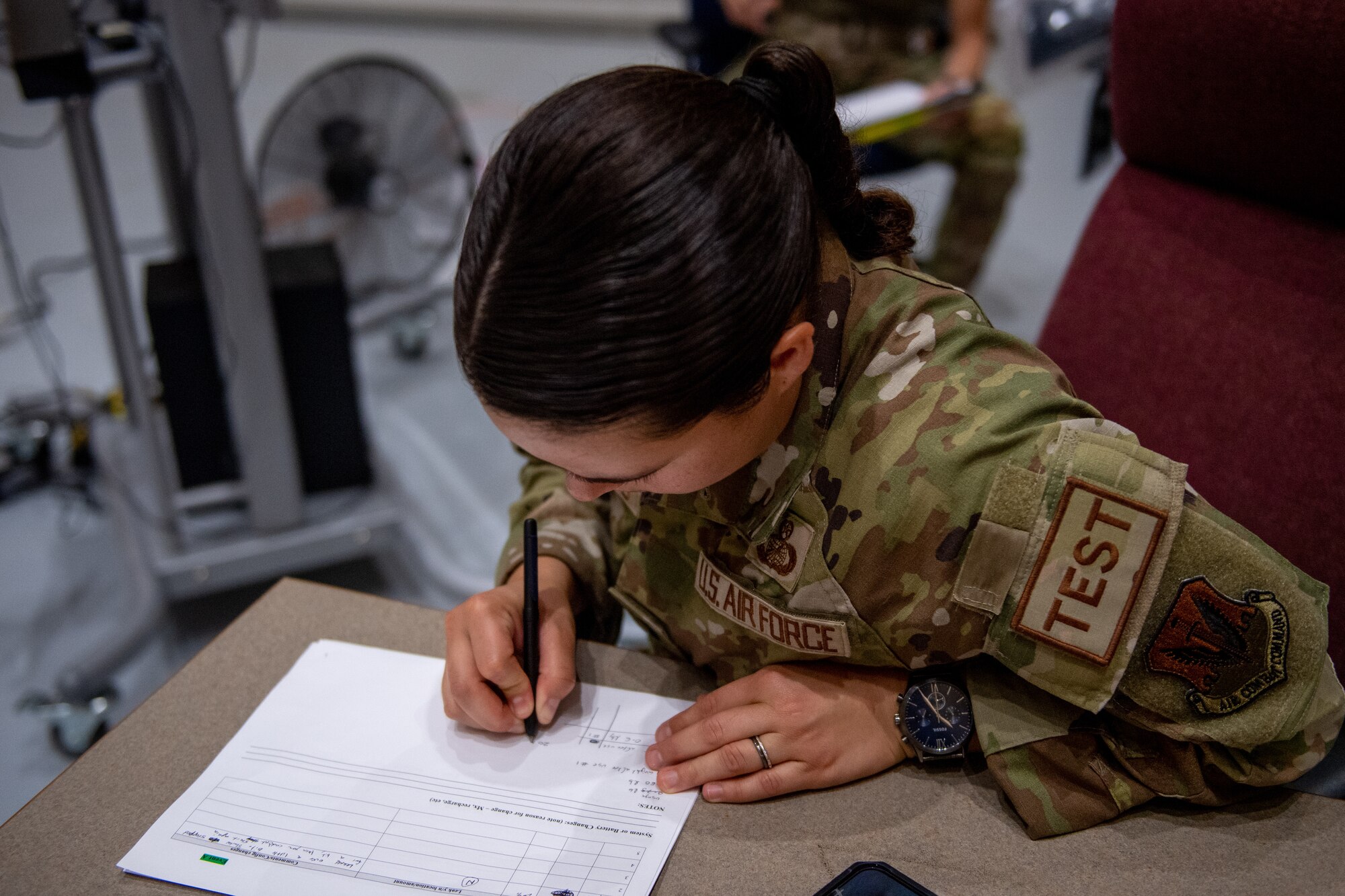 A U.S. Air Force Airman from the Air Force Life Cycle Management Center Human Systems Division documents test results at Moody Air Force Base, Georgia, Aug. 28, 2023. The new system design was developed to allow female pilots more comfort while flying. (U.S. Air Force photo by Senior Airman Courtney Sebastianelli)