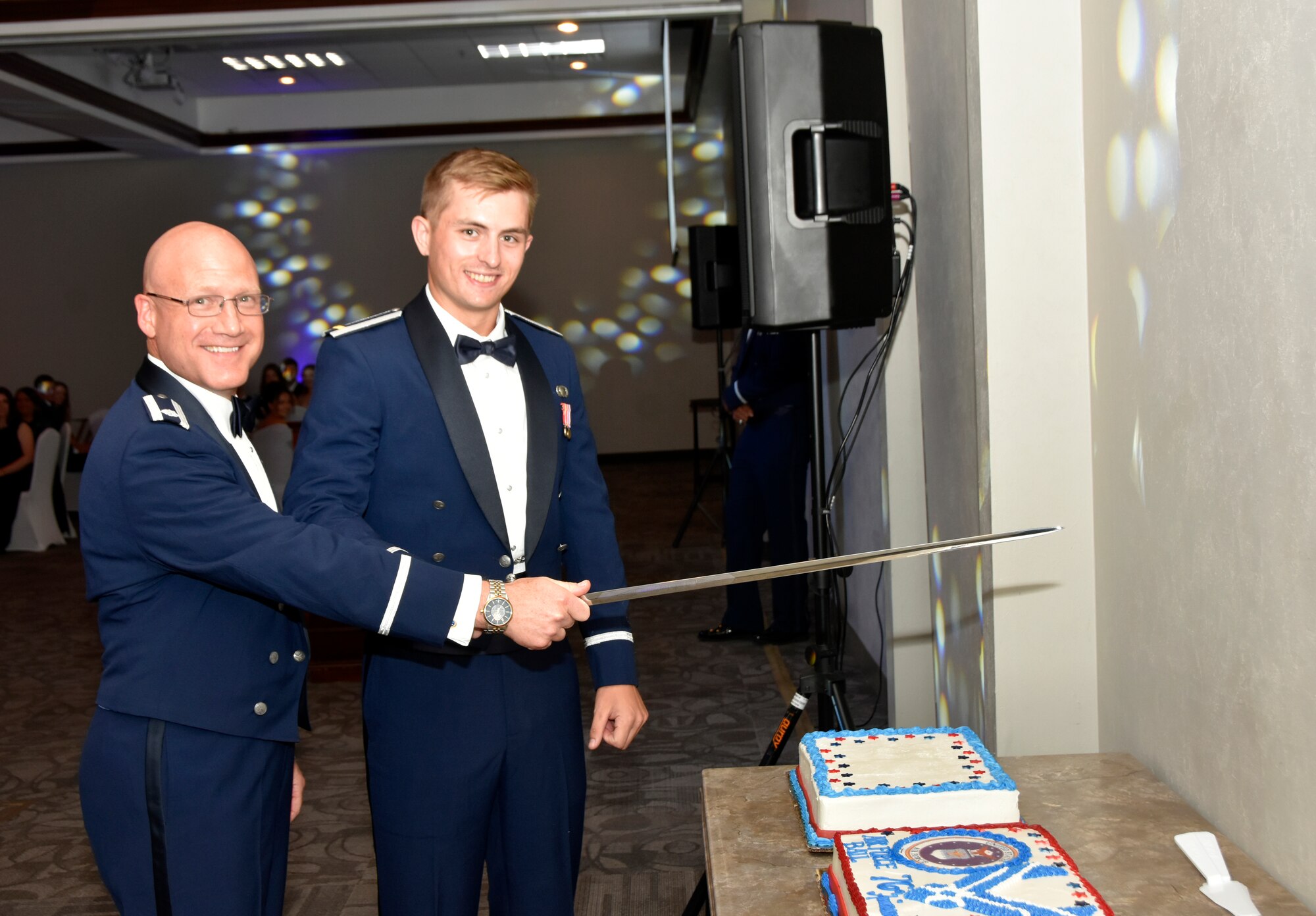 Lt. Col. Eric Withrow, left, and 2nd Lt. Patrick Robbins cut the Air Force birthday cake Sept. 9, 2023, during the Arnold Engineering Development Complex Air Force Ball. The ball, hosted by the Company Grade Officers’ Council at Arnold Air Force Base, Tenn., headquarters of AEDC, was held at the Manchester/Coffee County Conference Center to coincide with the celebration of the U.S. Air Force’s 76th birthday. It is tradition for the youngest Airman, in this case Robbins, and the oldest to cut the cake together. (U.S. Air Force photo by Bradley Hicks)