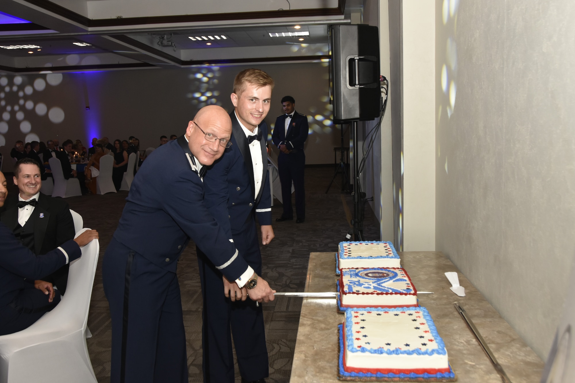 Lt. Col. Eric Withrow, left, and 2nd Lt. Patrick Robbins cut the Air Force birthday cake Sept. 9, 2023, during the Arnold Engineering Development Complex Air Force Ball. The ball, hosted by the Company Grade Officers’ Council at Arnold Air Force Base, Tenn., headquarters of AEDC, was held at the Manchester/Coffee County Conference Center to coincide with the celebration of the U.S. Air Force’s 76th birthday. It is tradition for the youngest Airman, in this case Robbins, and the oldest to cut the cake together. (U.S. Air Force photo by Bradley Hicks)