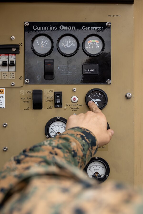 U.S. Marine Corps Cpl. Wyatt Szulewski, a wideband satellite communication operator with 9th Communication Battalion, I Marine Expeditionary Force Information Group, checks the fuel levels on a satellite communication subsystem during the I MIG Command Post Exercise on Marine Corps Base Camp Pendleton, California, Sept. 11, 2023. The I MIG CPX allows the force to balance future and current expeditionary operations utilizing the authorization to operate cycle in order to conduct, shape and sustain operations as directed by I MEF. (U.S. Marine Corps photo by Sgt. Anabel Abreu Rodriguez)