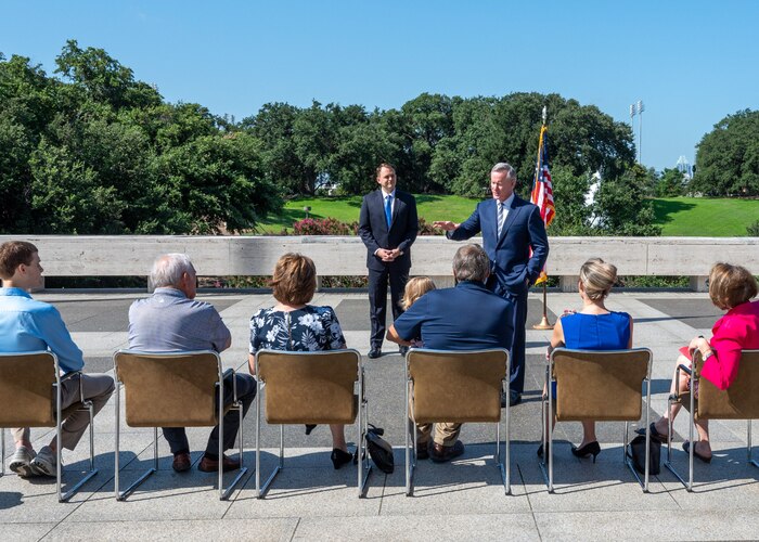 Retired U.S. Navy Admiral William McRaven, right, speaks to the family and friends of Capt. Michael K. Hole, left, a physician assigned to the 301st Medical Squadron, Naval Air Station Joint Reserve Base Fort Worth, Texas during Hole's oath of office ceremony.
