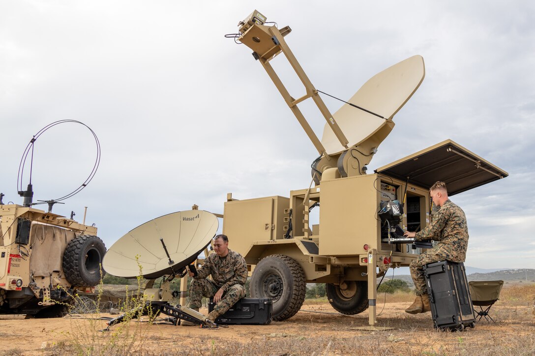U.S. Marine Corps Cpl. Clinton Mott, left, and Cpl. Wyatt Szulewski, both wideband satellite communication operators with 9th Communication Battalion, I Marine Expeditionary Force Information Group, setup connectivity utilizing a broadband access terminal and a satellite communication subsystem during the I MIG Command Post Exercise on Marine Corps Base Camp Pendleton, California, Sept. 11, 2023. The I MIG CPX allows the force to balance future and current expeditionary operations utilizing the authorization to operate cycle in order to conduct, shape and sustain operations as directed by I MEF. (U.S. Marine Corps photo by Sgt. Anabel Abreu Rodriguez)